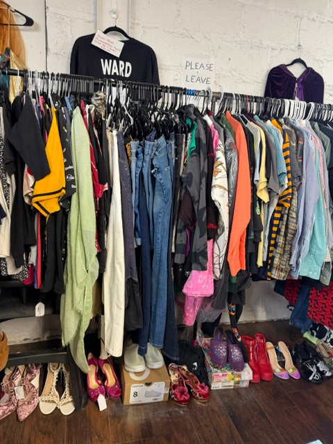 Clothing racks filled with vintage, contemporary and unique fashion finds inside Mrs. Bones Curio Cupboard Booth 386 at Treasure Trove Fleatique.