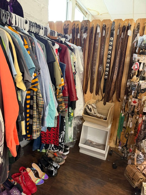 Clothing, jeans, dresses and shoes displayed for sale in Mrs. Bones Curio Cupboard Booth 386 at Treasure Trove Fleatique.