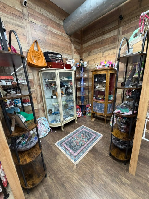 Mrs. Bones Curio Cupboard booth 420 at Treasure Trove Fleatique featuring display cabinets, designer finds, collectibles, handbags, and specialty pieces.