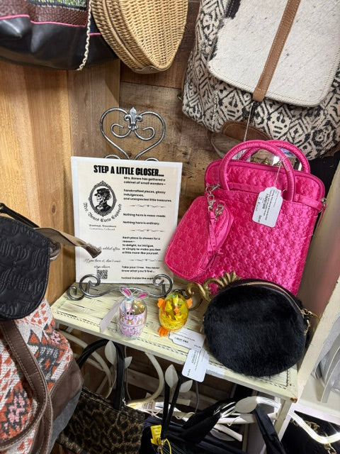 close up of handbags accessories and display sign inside Mrs Bones Curio Cupboard booth