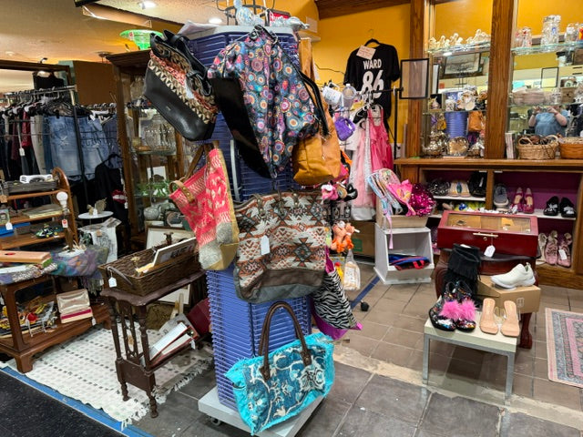 Vintage finds, handbags, shoes, and curiosities inside Mrs. Bones Curio Cupboard at The Rusty Crown, Booth 571 in Pittsburgh, Pennsylvania.