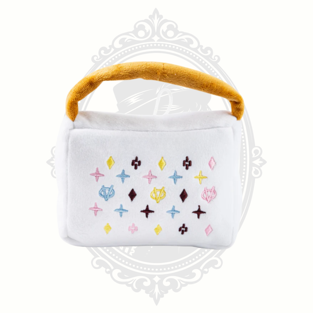 White plush dog toy handbag with colorful embroidered pattern and soft handle for interactive play