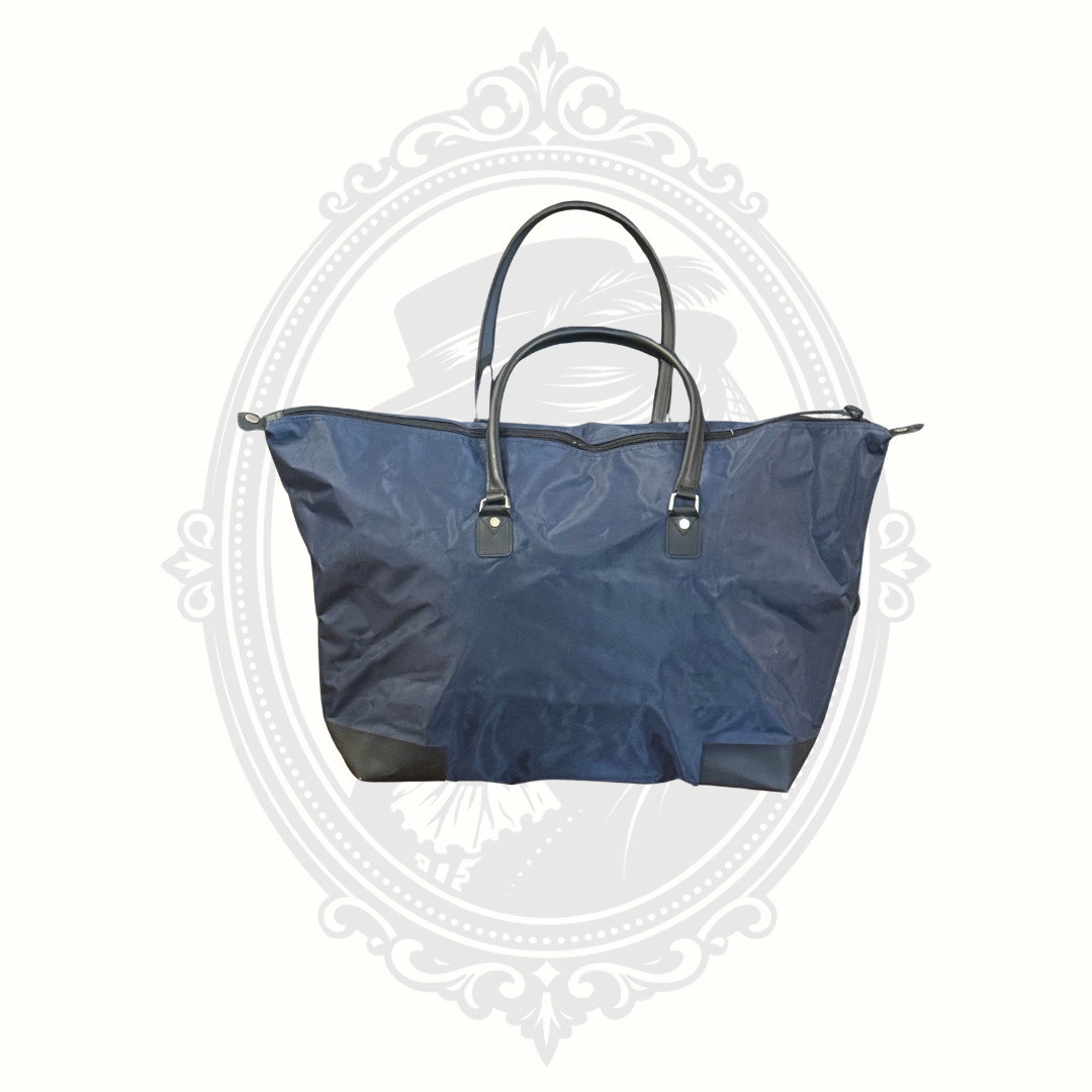 Back view of Walt Disney World foldable travel tote bag with navy nylon body and black handles