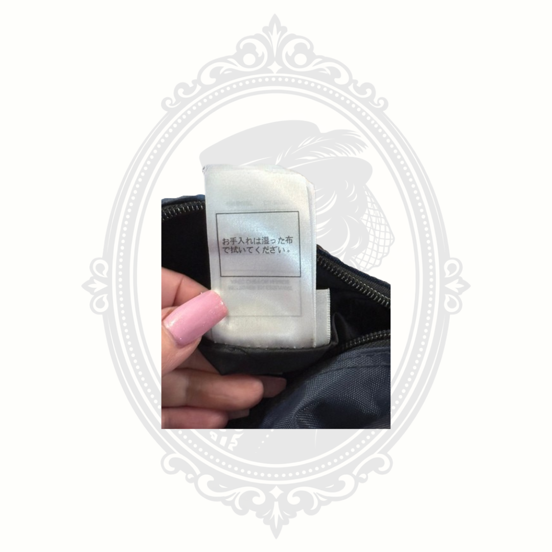 Close-up of Walt Disney World travel bag care tag with Japanese text and fabric label details