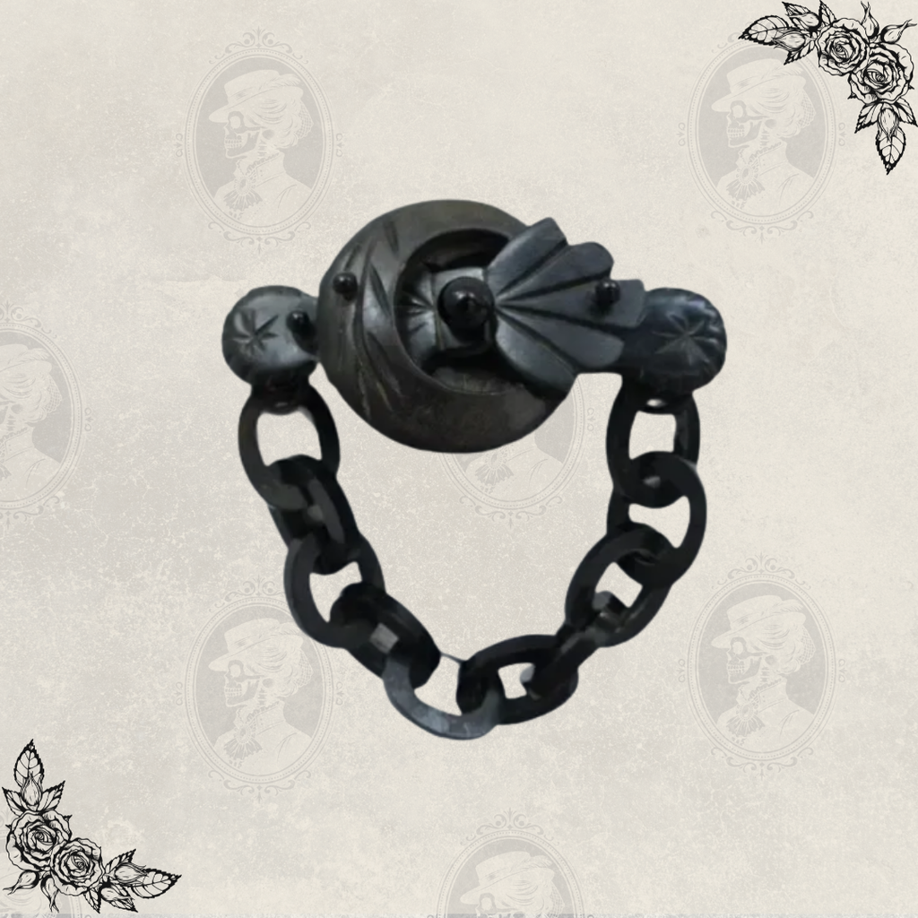 Angled view of Victorian mourning brooch with linked chain detail, showcasing depth and carved design in gutta percha