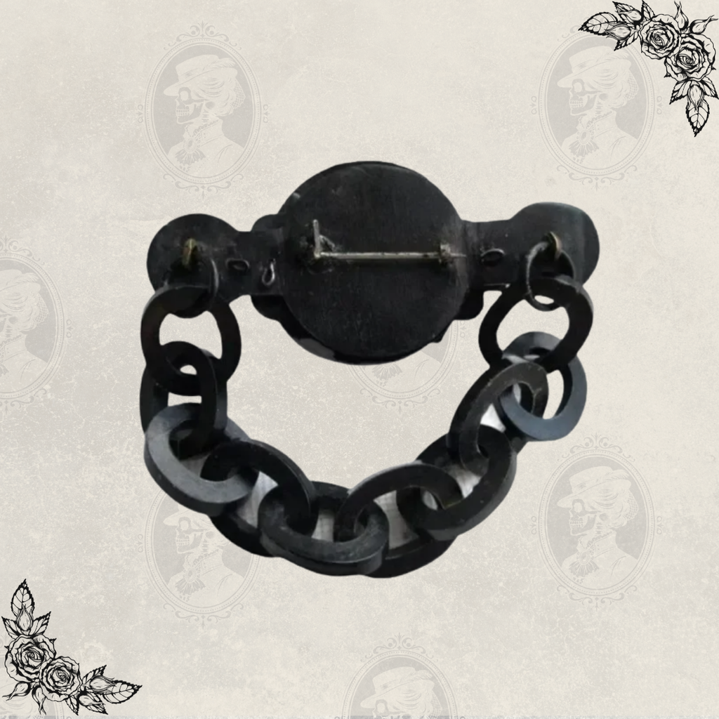 Back view of antique Victorian mourning brooch displaying original C clasp closure and chain attachment