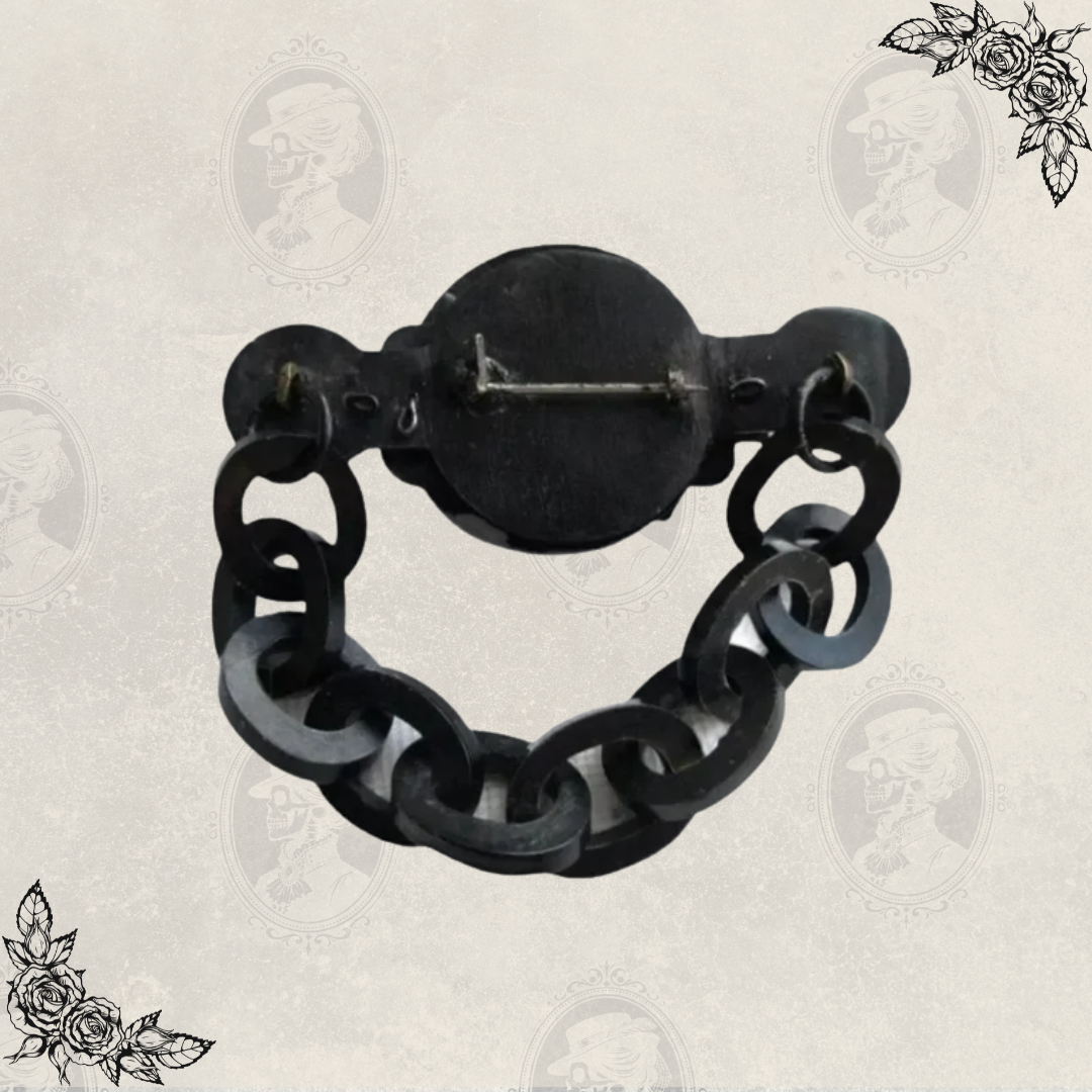 Back view of antique Victorian mourning brooch displaying original C clasp closure and chain attachment