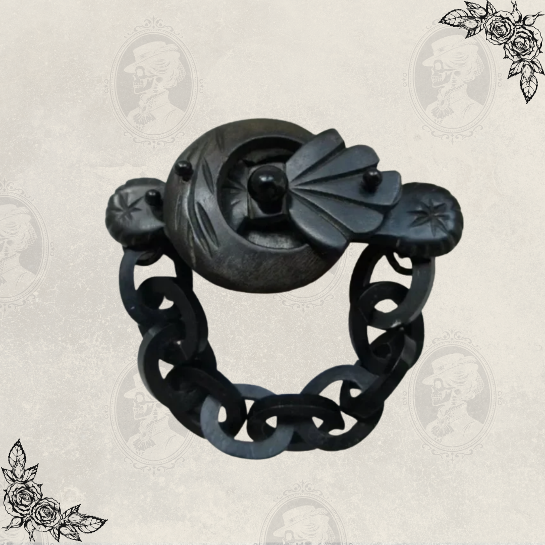 Front view of antique Victorian mourning brooch with chain drop, made of carved gutta percha, associated with Odd Fellows