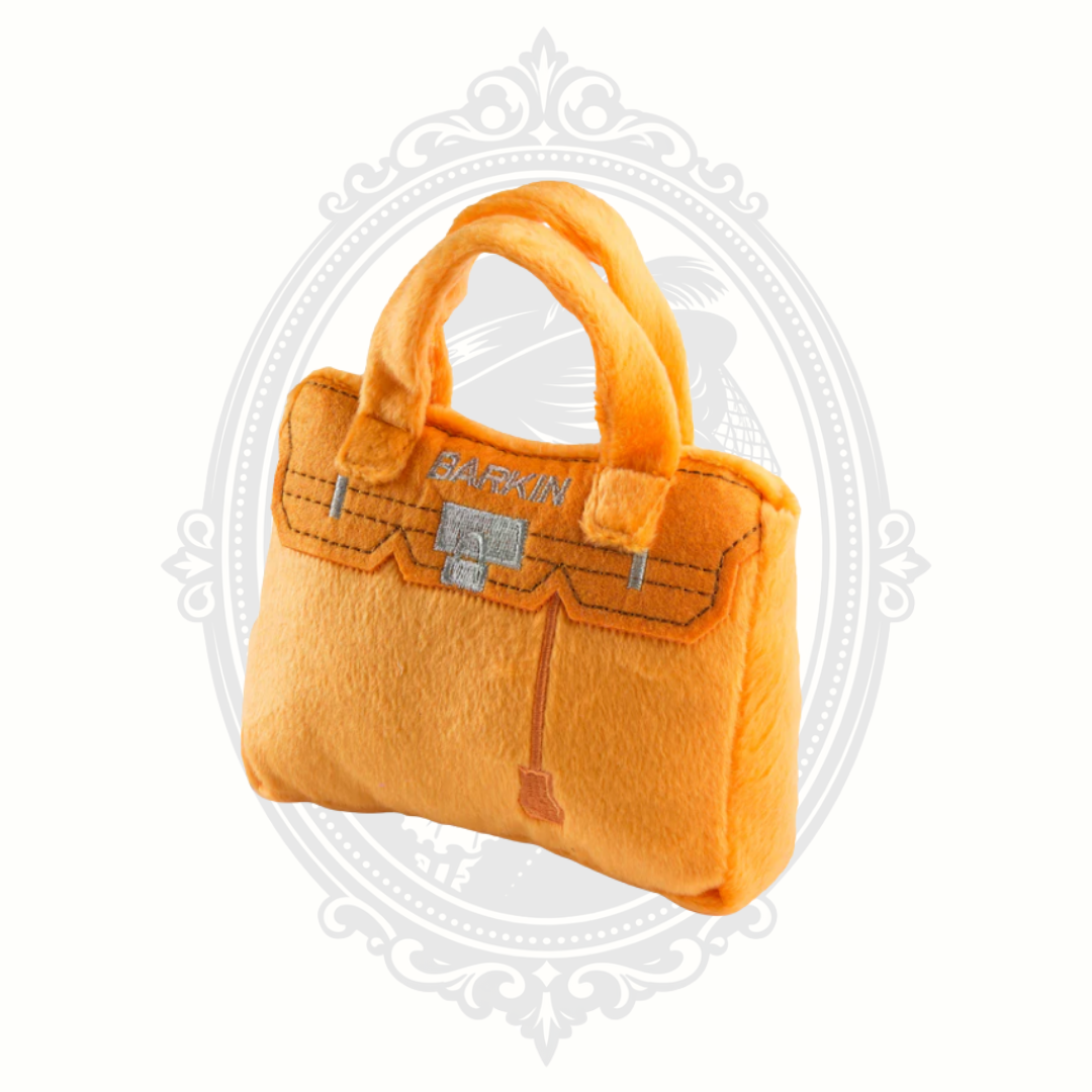 Orange plush dog toy handbag with structured shape and soft fabric for stylish pet play