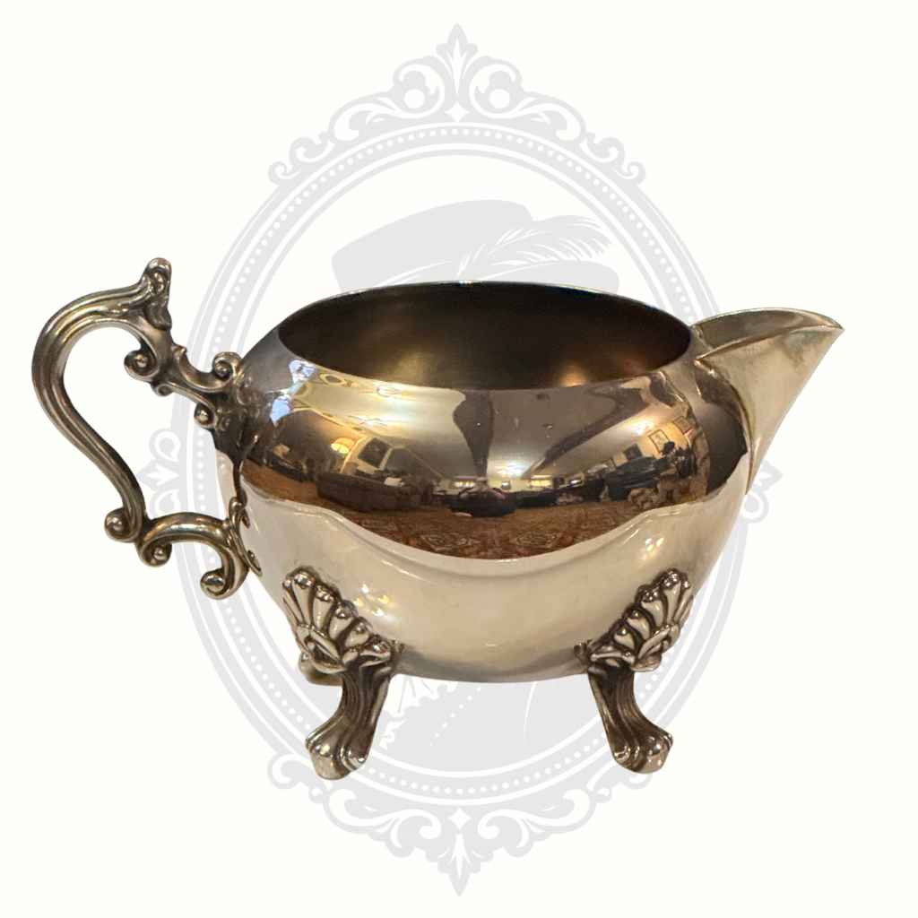 Silver-plated ornate sugar bowl on a white background