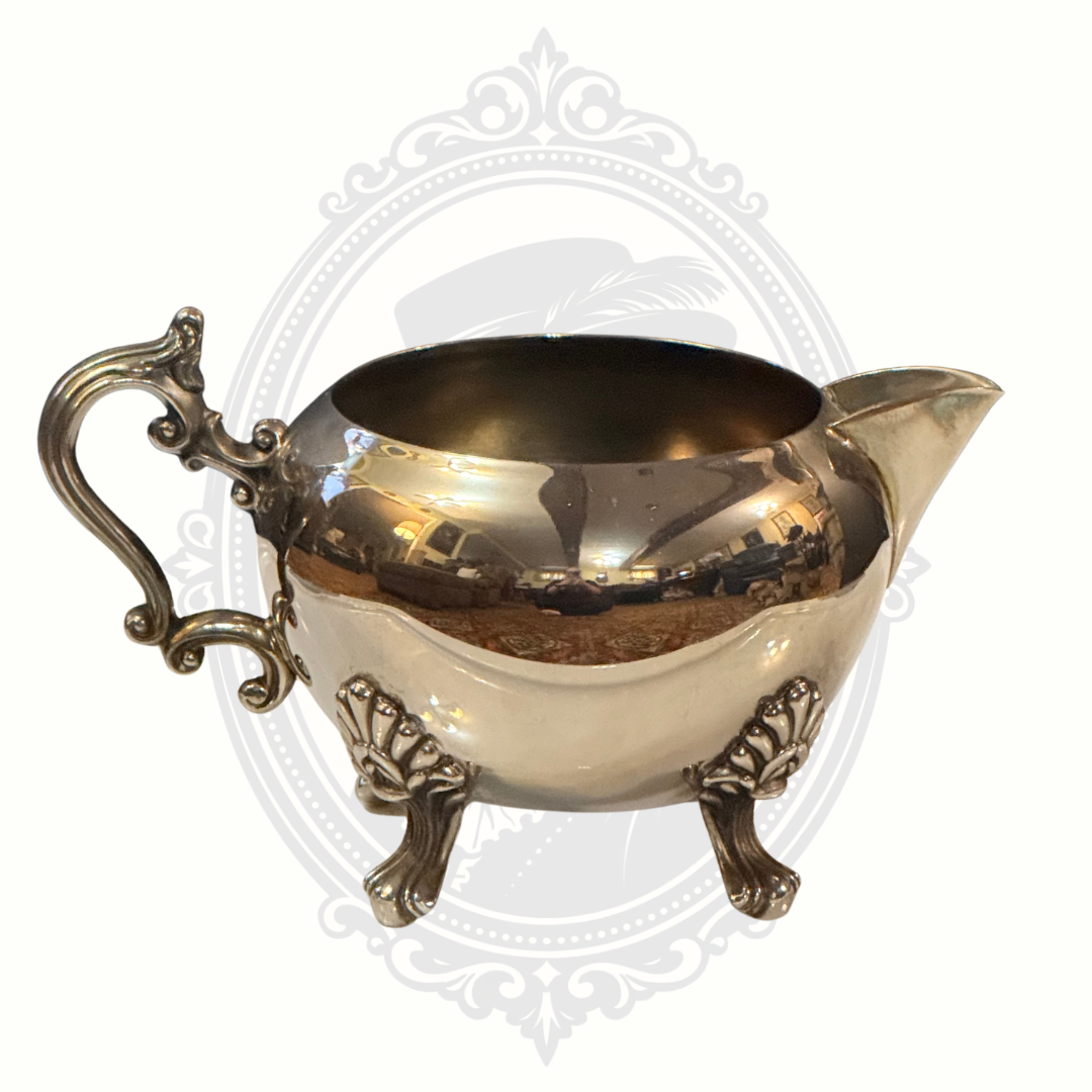 Silver-plated ornate sugar bowl on a white background