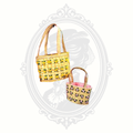 Angled view of two woven baskets with floral embroidery and braided handles, showing texture and design