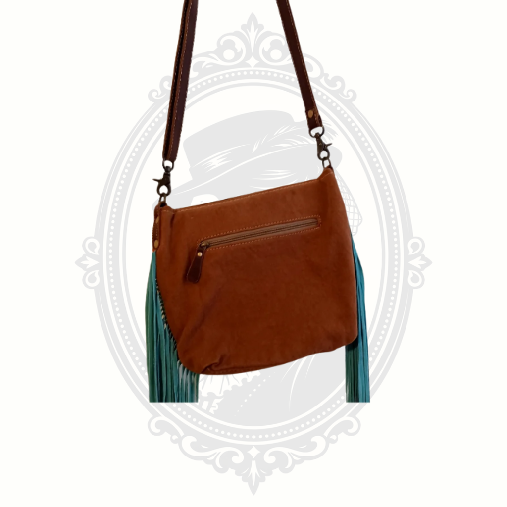 Back view of Myra Bag crossbody showing smooth leather panel with zipper pocket and adjustable strap.
