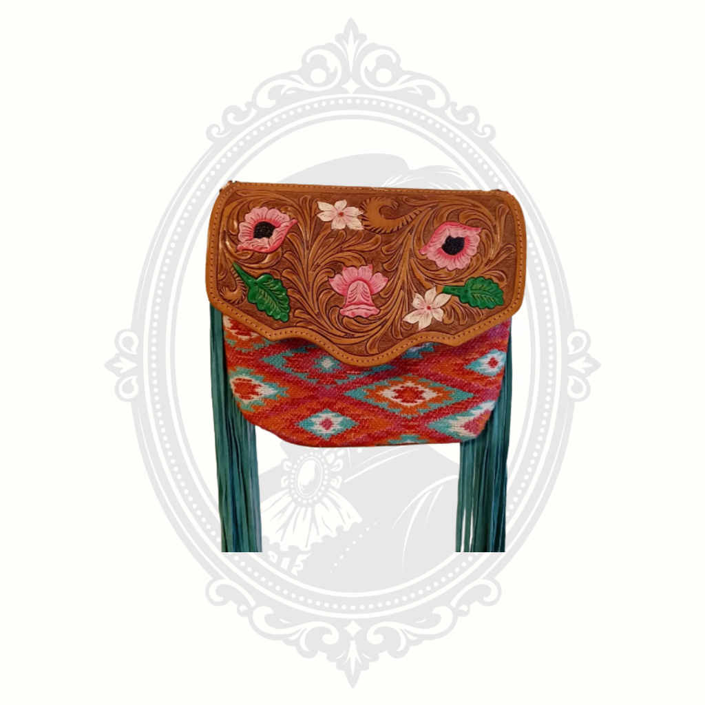 Full view of Myra Bag crossbody with long fringe, floral tooled leather flap, and woven patterned body.