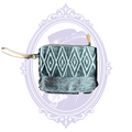 Front and back views of Myra black and gray diamond-pattern wristlet, with hair-on-hide trim and wrist strap.