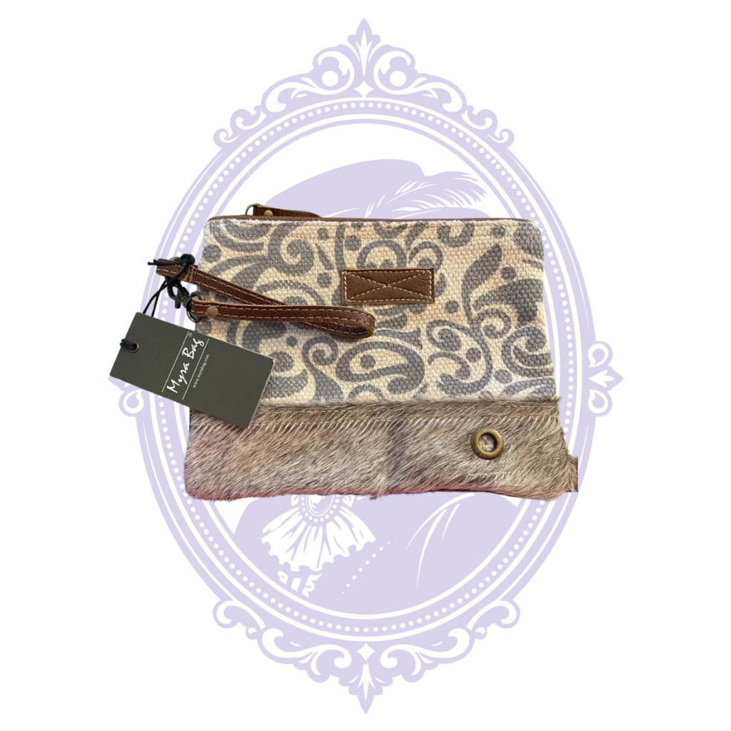 Front of Myra Reinvention Pouch in gray and cream scroll canvas with hair-on-hide lower panel and original hangtags