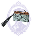 Front view of Myra teal spotted hair-on-hide wristlet and tooled brown leather trim