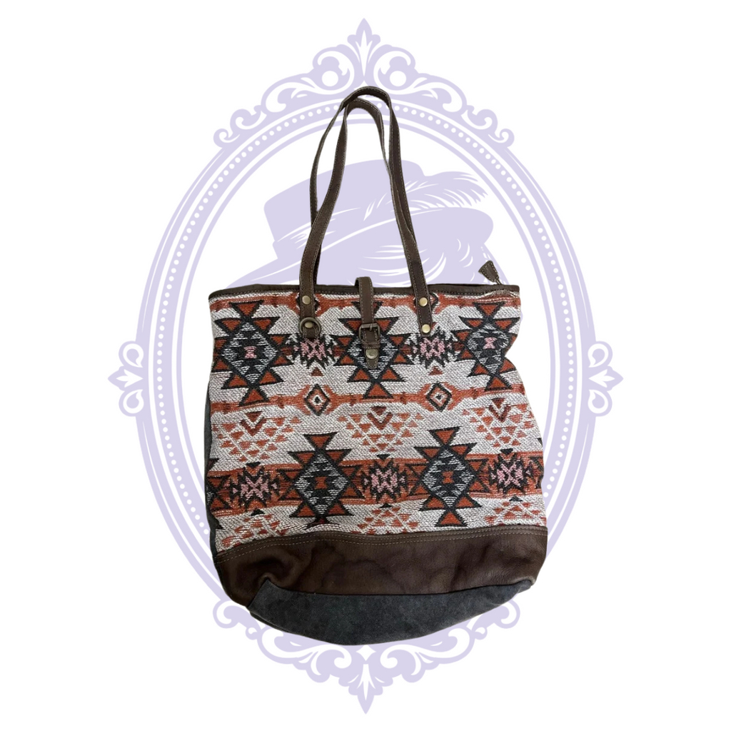 Close-up of Myra Bag label and printed interior lining of tribal pattern tote.