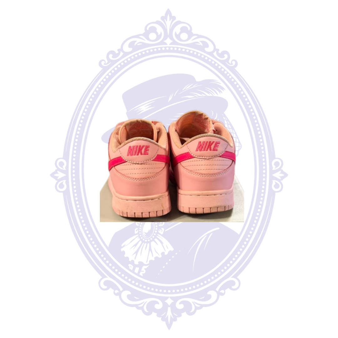 Rear view of Nike Dunk Low Triple Pink size 7 sneakers showing embroidered Nike heel branding and condition