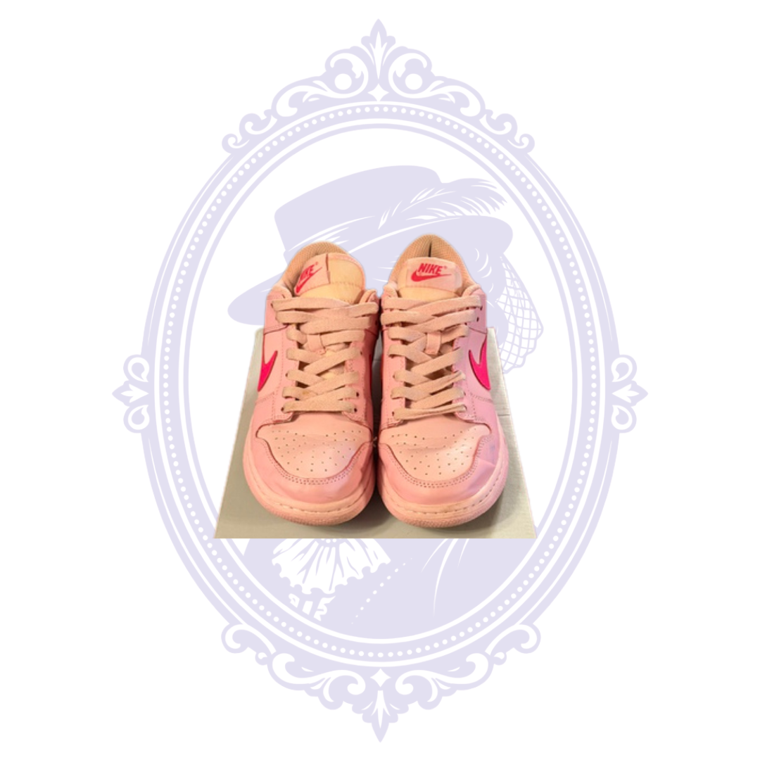 Overhead view of Nike Dunk Low Triple Pink size 7 sneakers showing pink laces, perforated toe boxes and Nike tongue labels