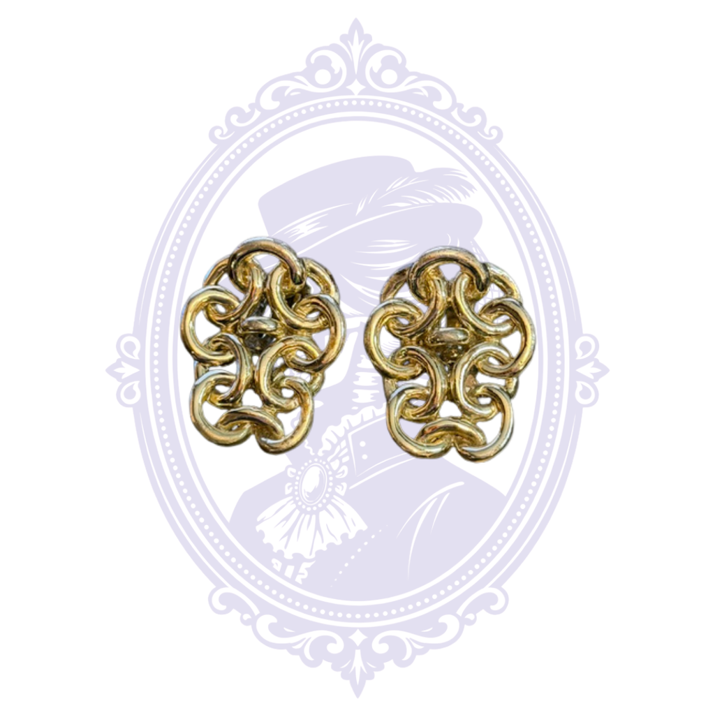 Ornate gold-tone clip earrings featuring an openwork scrolling filigree pattern.