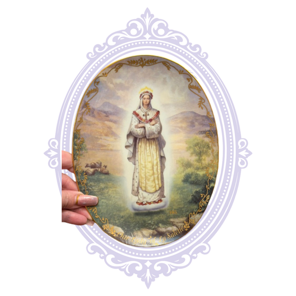 Our Lady of La Salette plate shown in hand for scale
