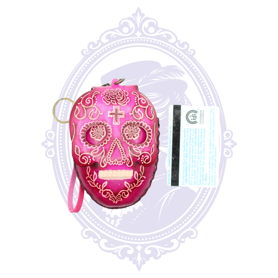 Pink leather sugar skull coin purse shown beside a standard card for size reference.