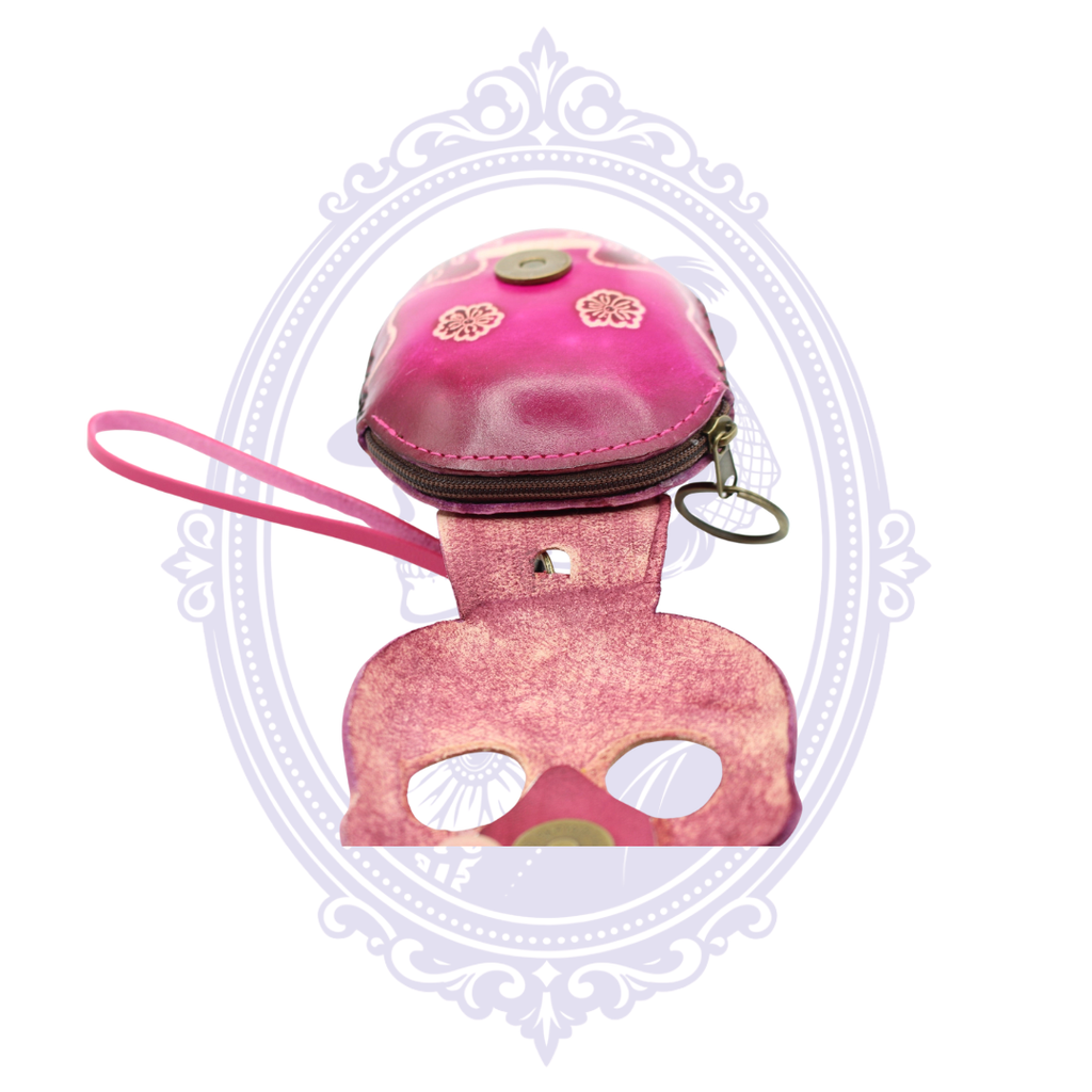 Open pink leather sugar skull coin purse showing the zippered compartment, wrist strap and key ring.