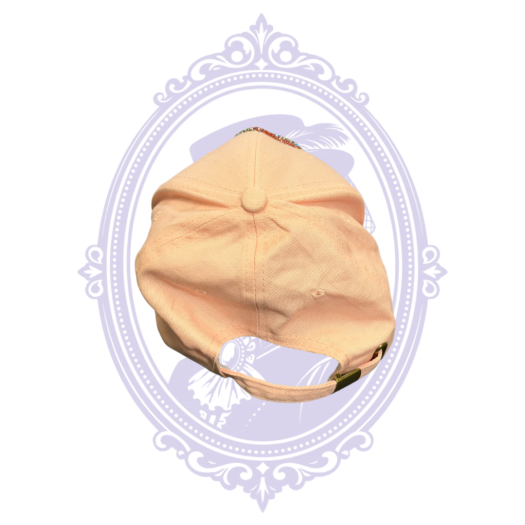Angled front view of pink rhinestone awareness ribbon adjustable baseball cap