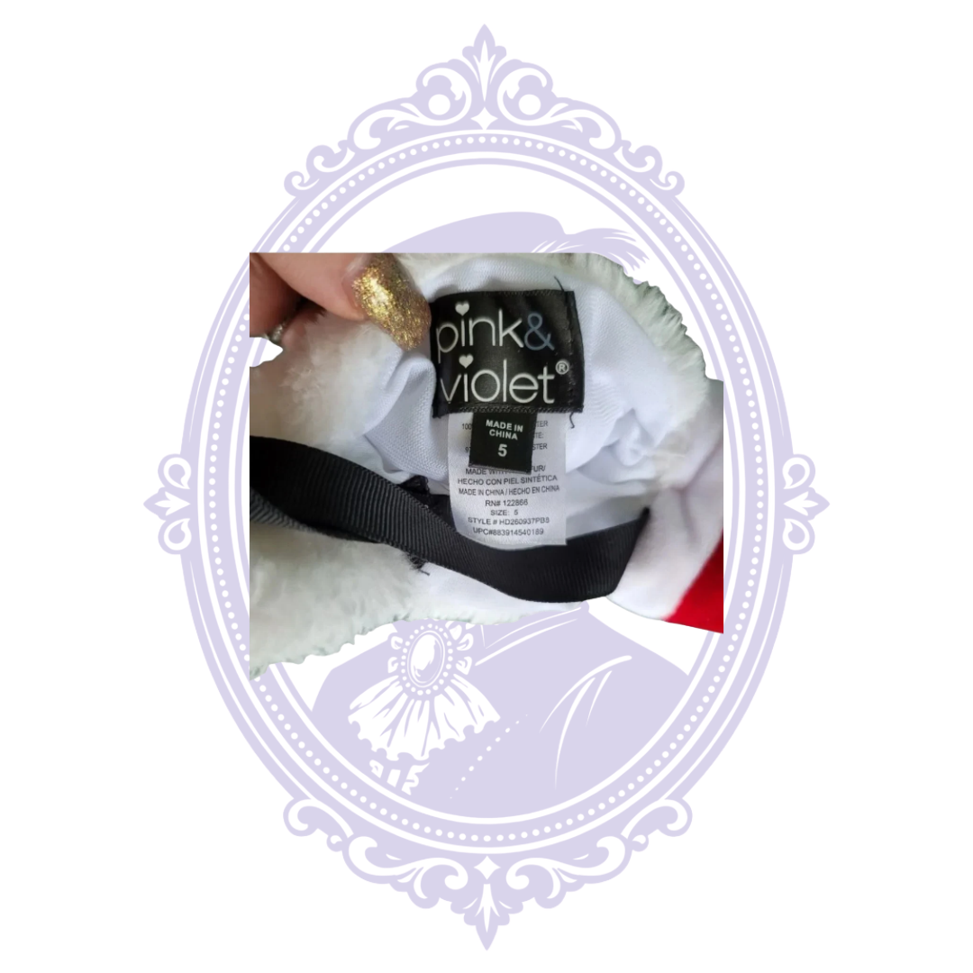 Front of plush white polar bear Christmas purse with Santa hat and black strap