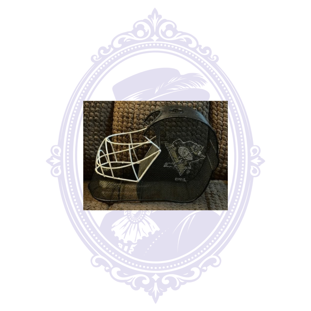 Left side view of Pittsburgh Penguins goalie mask wine cork holder featuring the Penguins logo, black metal mesh, and white goalie face cage.