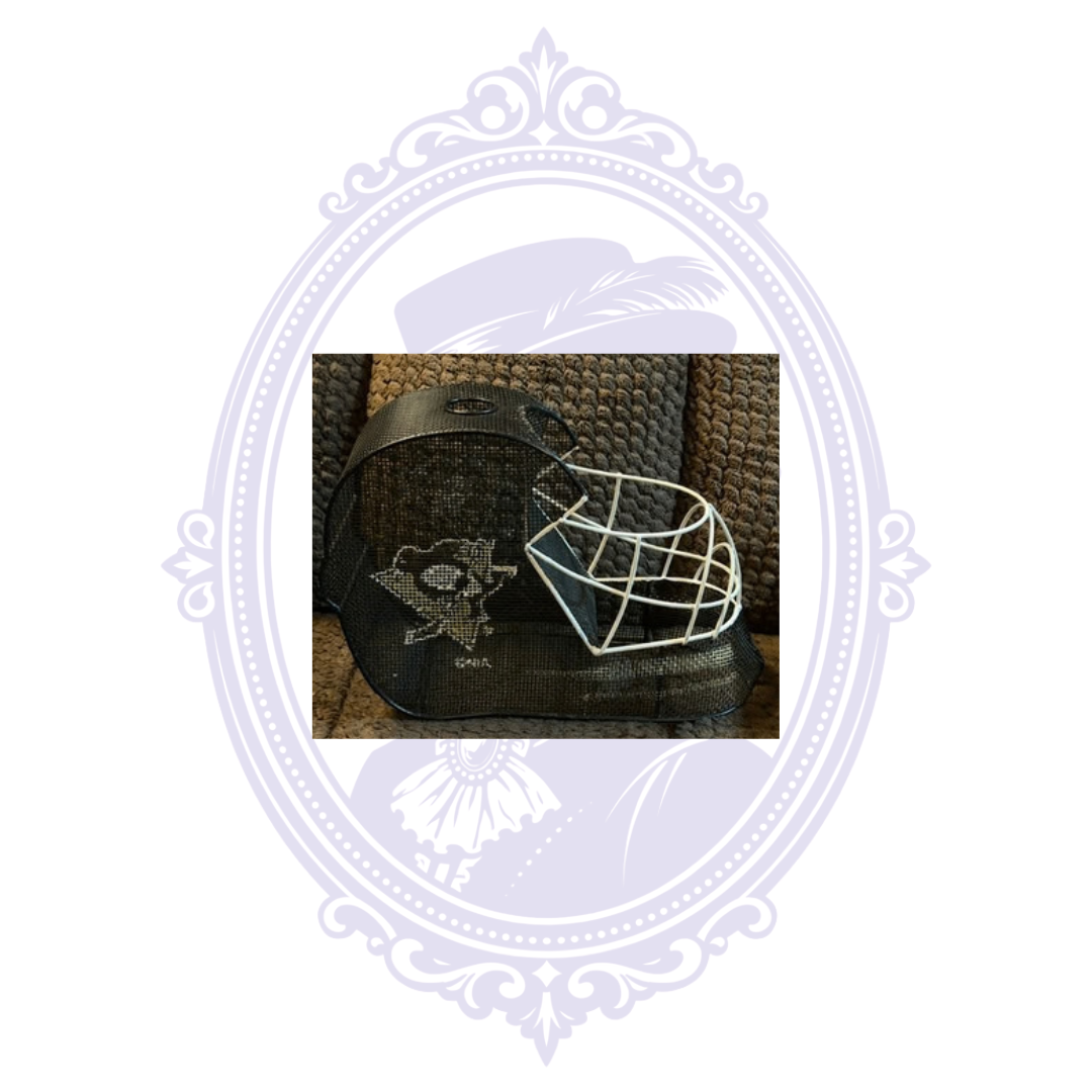 Right side view of Pittsburgh Penguins goalie mask wine cork holder featuring the Penguins logo, black metal mesh, and white goalie face cage.