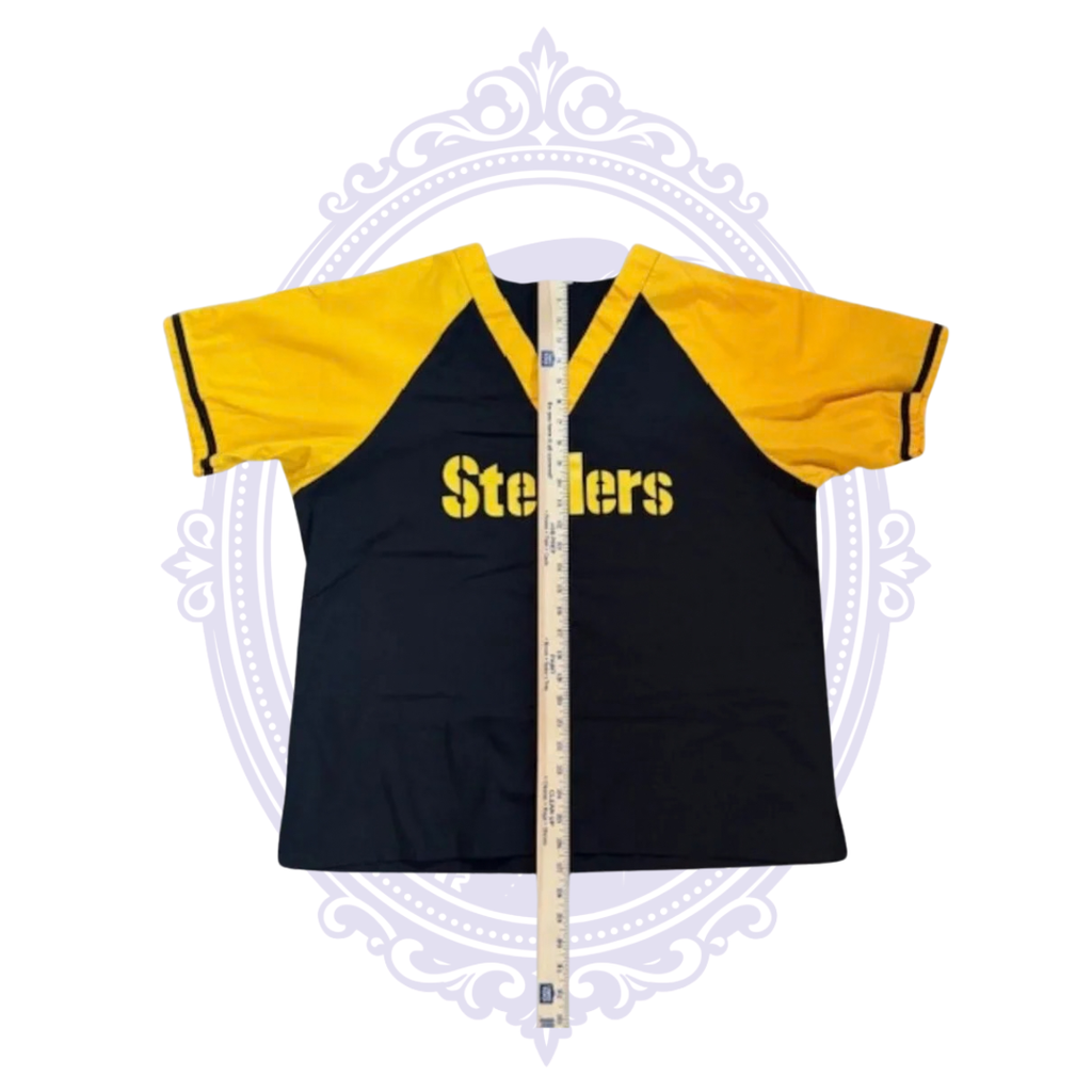 Pittsburgh Steelers black and gold scrub top laid flat with ruler from neckline to hem to show garment length.