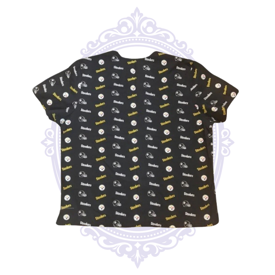 Back view of Pittsburgh Steelers women’s scrub top with black fabric and all-over Steelers logos, helmets and black and gold print.