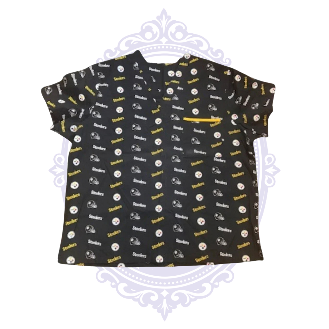 Front view of Pittsburgh Steelers women’s black scrub top with all-over team logos, helmet print and contrasting yellow zippered chest pocket.