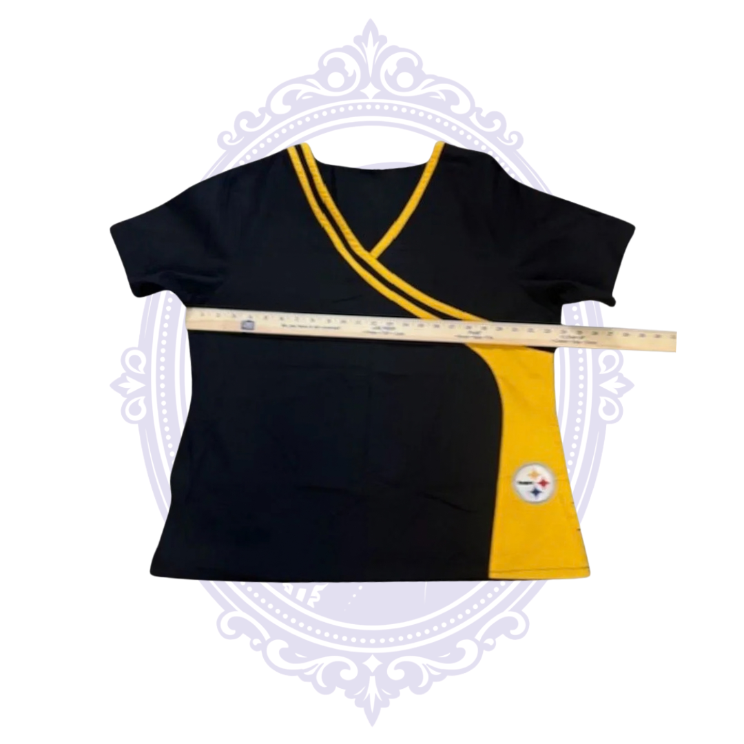 Pittsburgh Steelers women’s scrub top laid flat with ruler across the chest to show width.