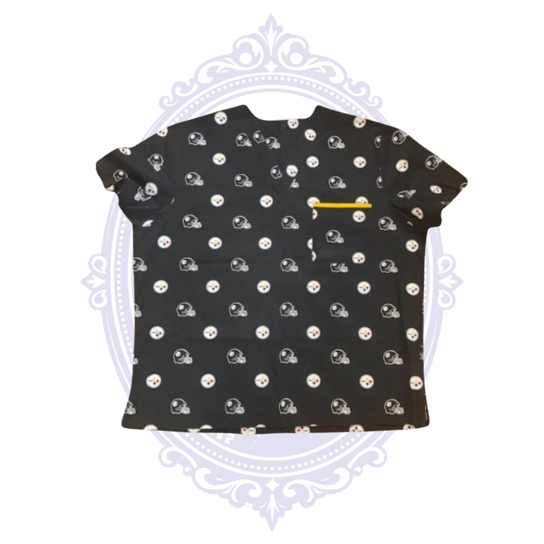 Front view of black Pittsburgh Steelers women’s scrub top with repeating helmet and team logos and gold-trimmed chest pocket.
