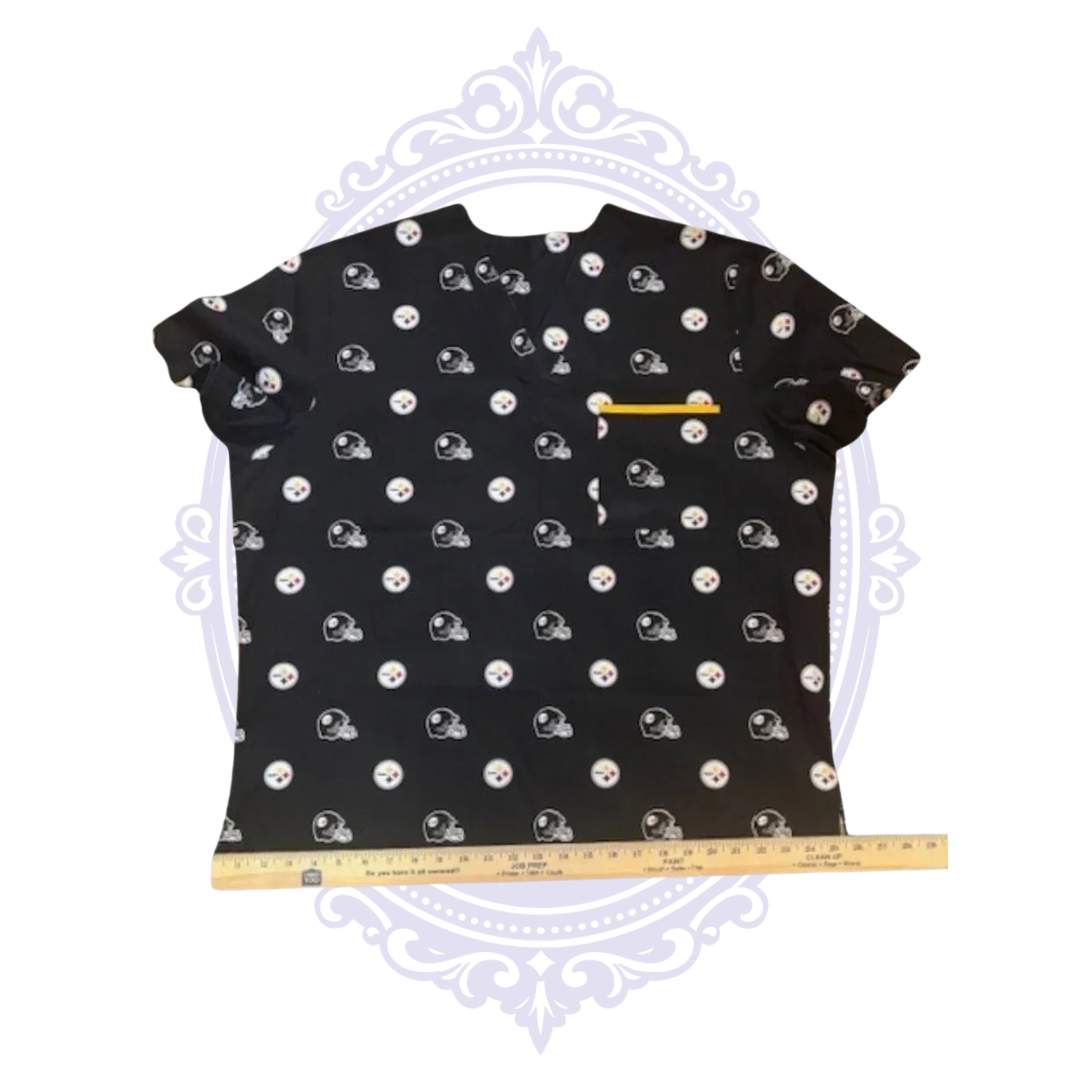 Pittsburgh Steelers helmet and team logo scrub top shown with ruler across the bottom hem for width measurement.