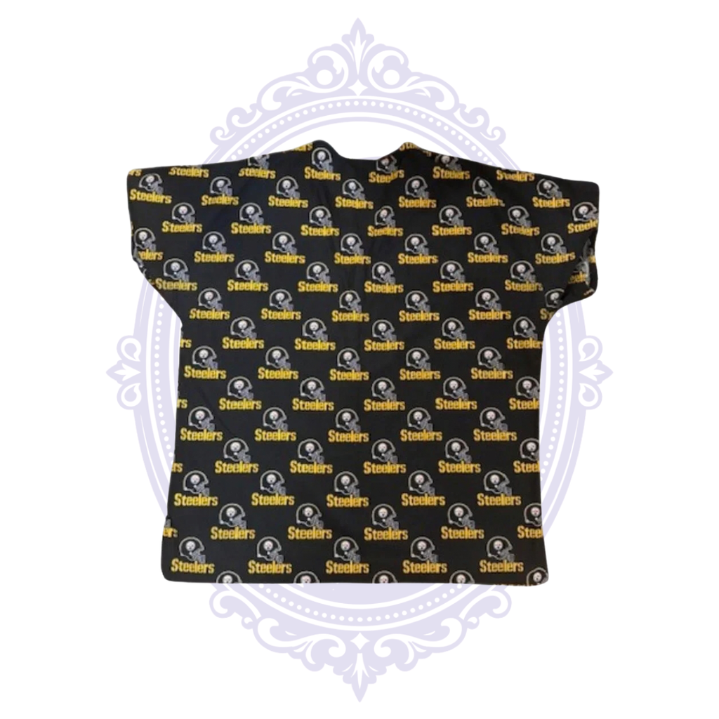 Back view of Pittsburgh Steelers black scrub top with repeating helmet logos and gold Steelers wordmarks.