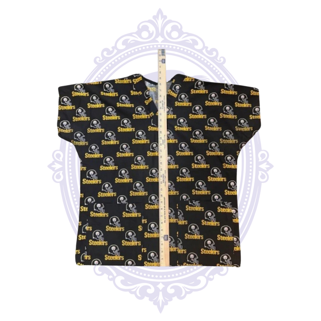 Pittsburgh Steelers helmet print scrub top laid flat with ruler showing garment length.