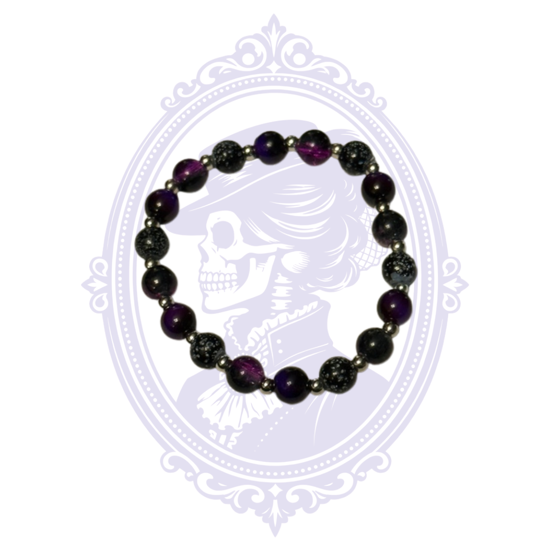 Purple and black mixed glass bead bracelet with silvery detailed beads and silver-tone spacers.