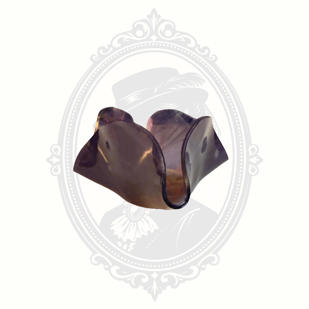 Side view of purple iridescent art glass bowl with ruffled edge and reflective carnival glass styling.