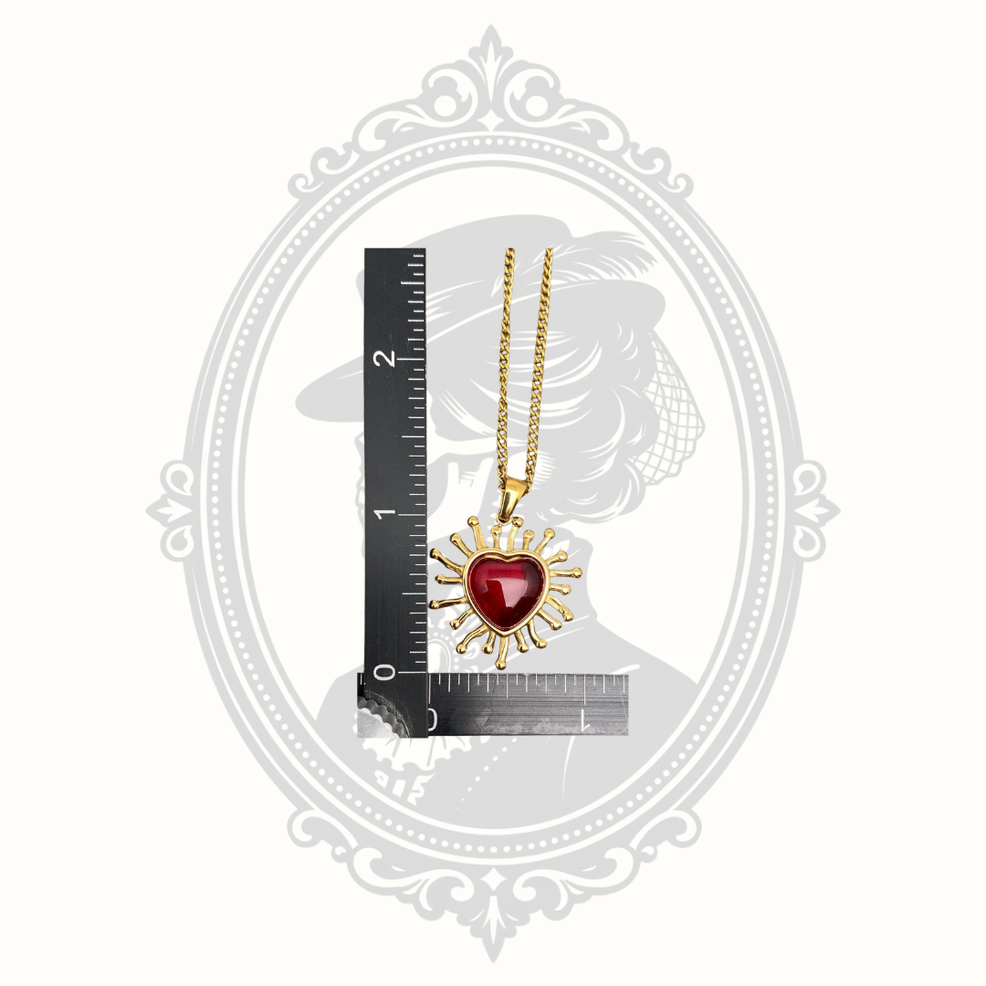 Radiant red heart pendant necklace shown beside a ruler for size reference.