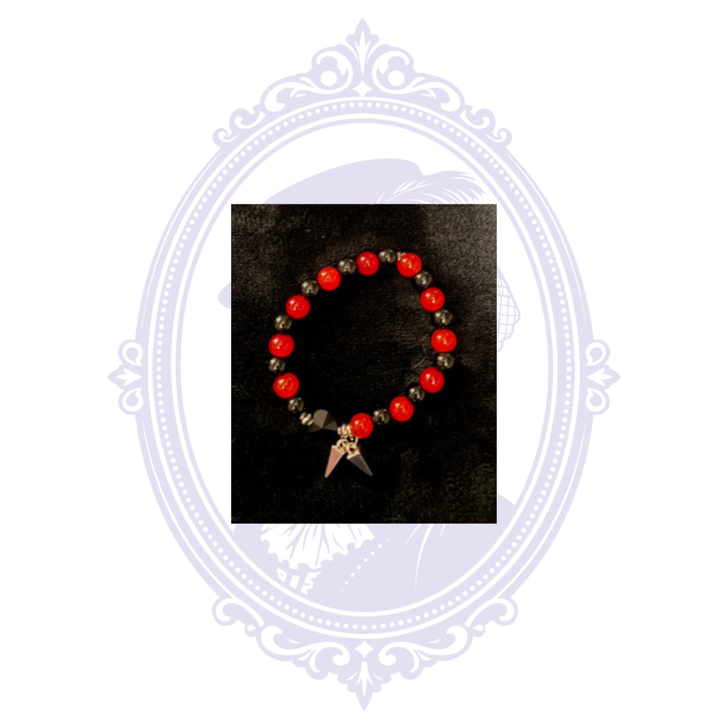 Red and black beaded gothic bracelet with dangling double-spike charms.