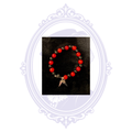 Red and black beaded gothic bracelet with dangling double-spike charms.