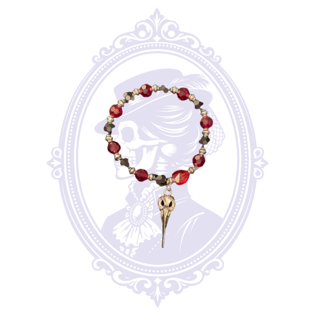 Red faceted glass bead bracelet with dark metallic accents and plague doctor bird skull charm.