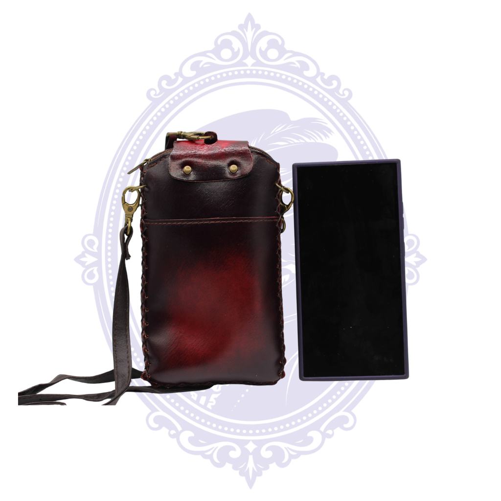 Back view of red leather sugar skull cell phone crossbody holder showing exterior pocket, strap attachments and size reference.