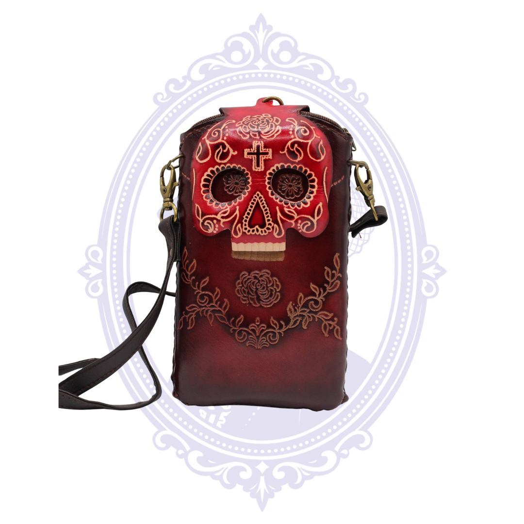 Front view of red genuine leather cell phone crossbody holder with dimensional sugar skull flap and floral detailing.