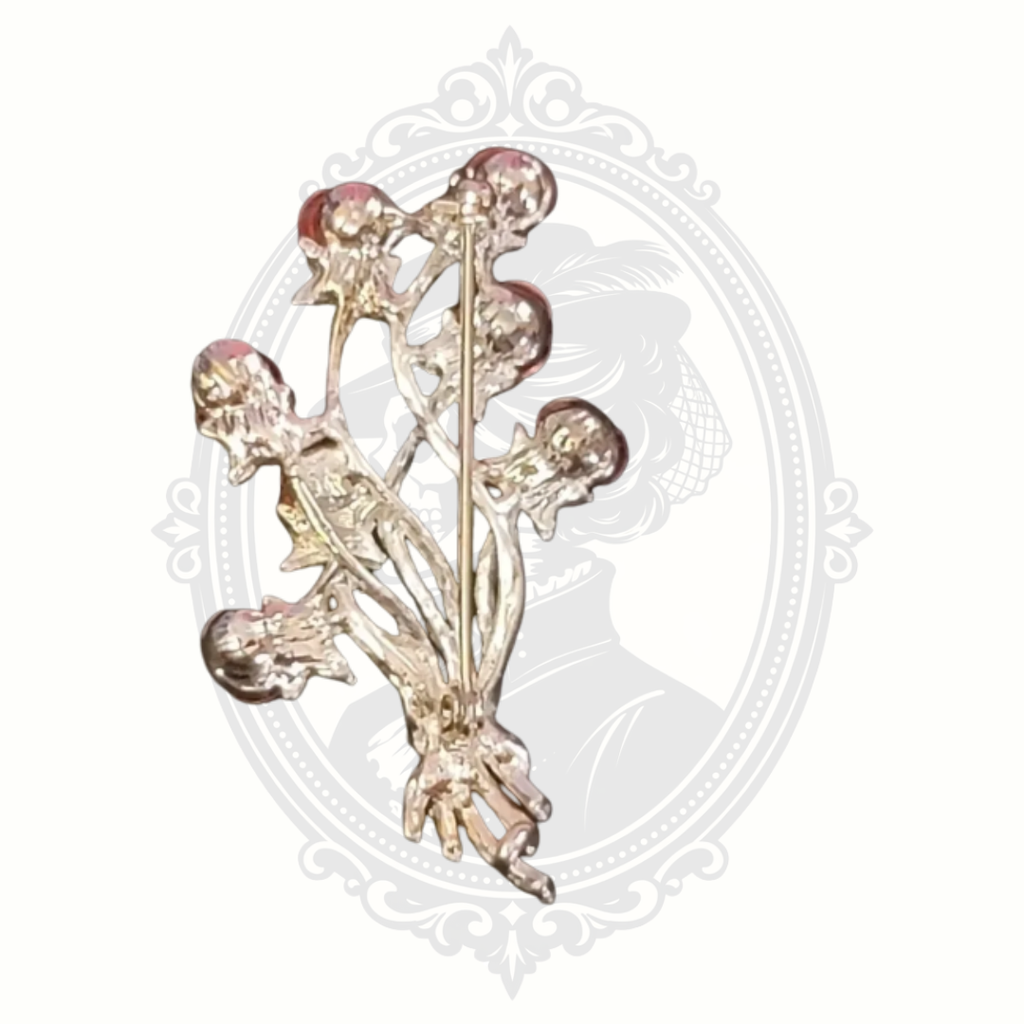 Back view of floral brooch showing pin mechanism and metal structure.