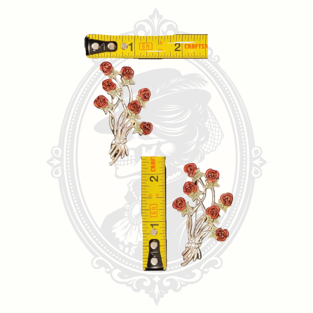 Rose bouquet brooch shown with measuring tape for size reference on a neutral background.